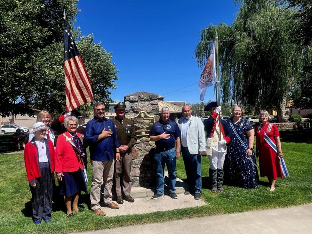 Community members and officials gather at a historic marker during the New Mexico National Guard 250th anniversary celebration